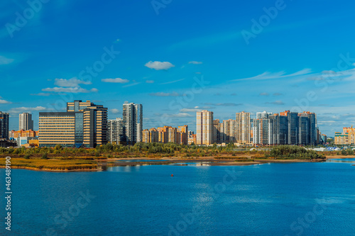 Residential neighborhoods of a Russian city. Residential areas with high-rise buildings in Kazan, Tatarstan. Houses on the banks of the river © Adsloboda