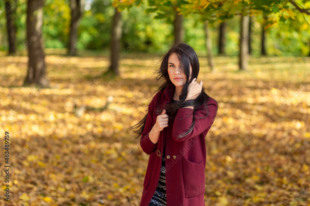 Portrait of a joyful young woman enjoying in the autumn park. Portrait of a joyful young woman enjoying in the autumn park.