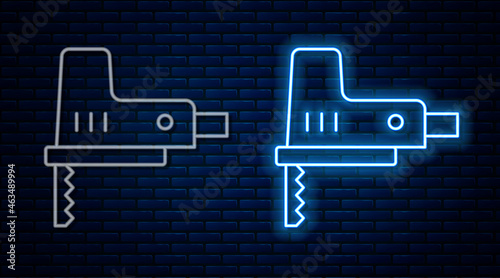 Glowing neon line Electric jigsaw with steel sharp blade icon isolated on brick wall background. Power tool for woodwork. Vector