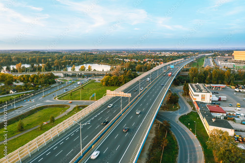 Fototapeta premium Highway with city and sunset views, aerial photography
