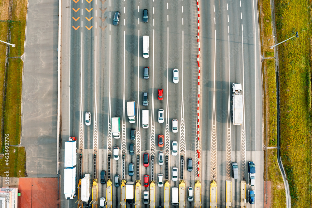 An overhead view of a busy toll road with many cars queuing up to pay An overhead view of a busy toll road with many cars queuing up to pay