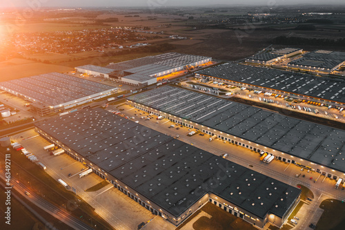Night aerial view of a warehouse of goods for online stores. Logistic center in the industrial area of the city from above.
