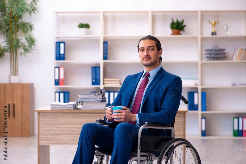 Young disabled employee working in the office Young disabled employee working in the office