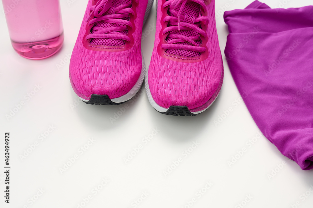 Φωτογραφία pair of textile purple sports sneakers on a white background