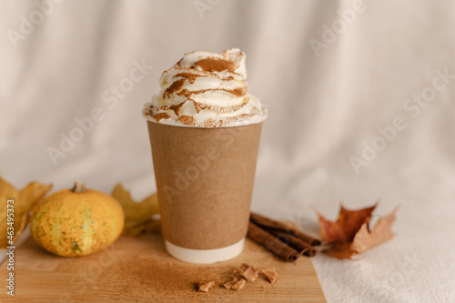 Coffee Take Away Cup in Autumn Pumpkin Set Up. Pumpkin spice latte with whipped cream and fresh cinnamon. Coffee to go with Cream and Cinnamon on Top. Autumn Latte Cinnamon