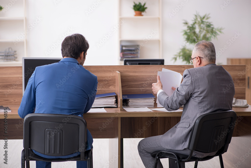 Two male employees working in the office