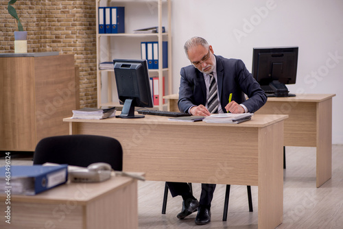 Aged businessman employee sitting in the office