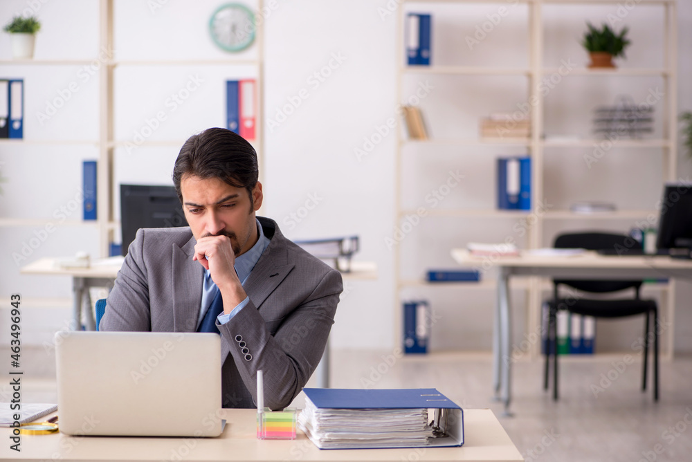 Young male employee working in the office Young male employee working in the office