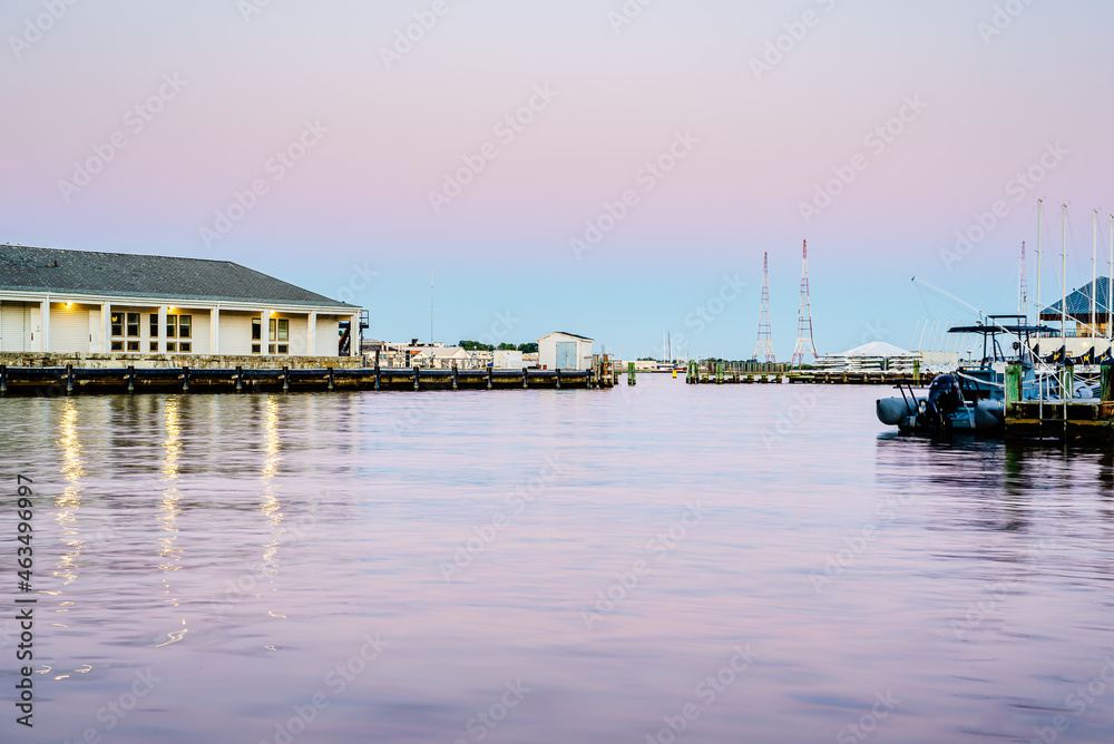 pink sunset over marina and river with sailboats
