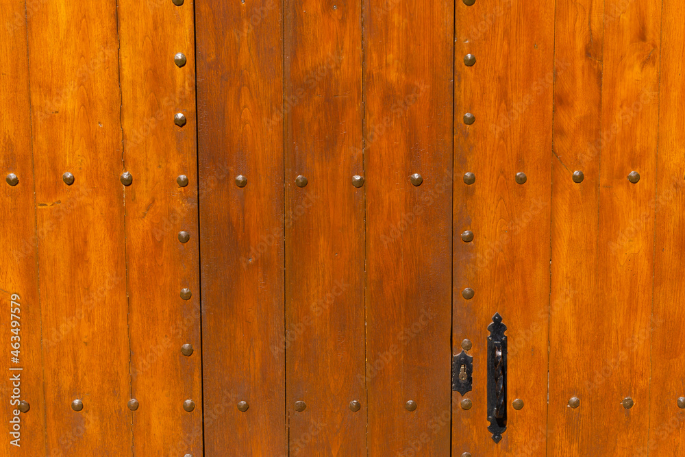 Old wooden door with iron handle Old wooden door with iron handle