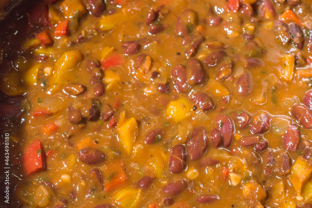 beans with vegetables and yellow sauce in an aluminum pan beans with vegetables and yellow sauce in an aluminum pan