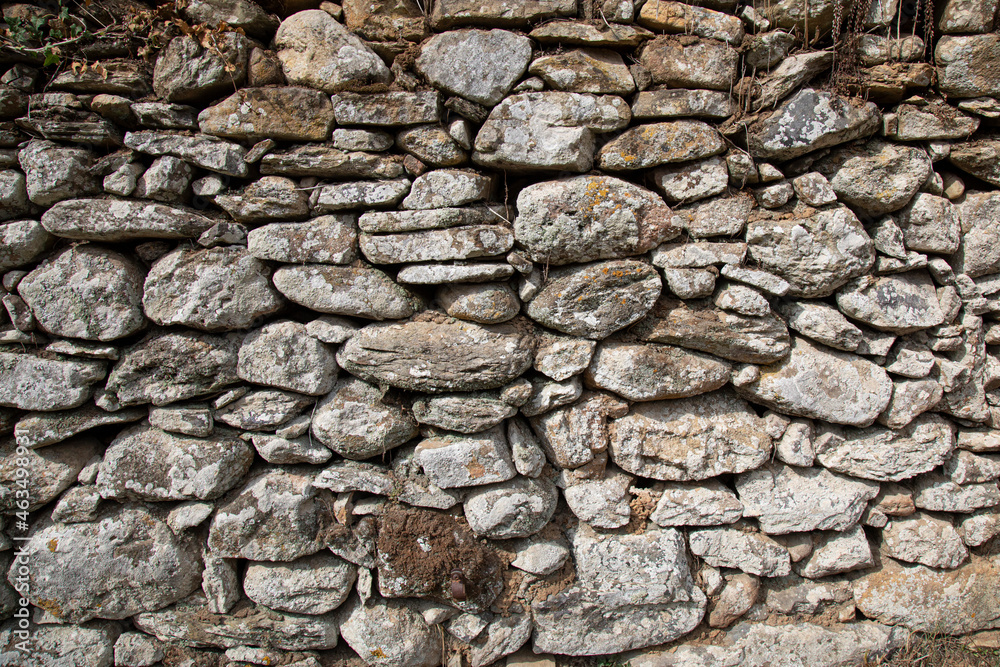 Rough texture of the ancient natural stone wall