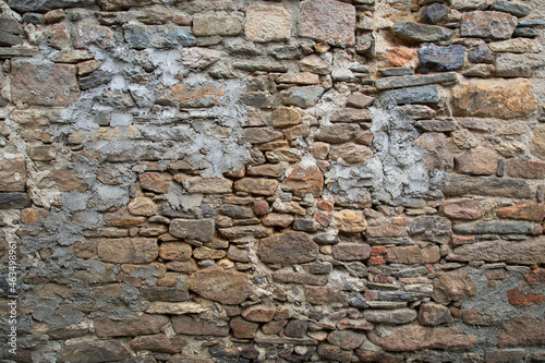 Rough texture of the ancient natural stone wall