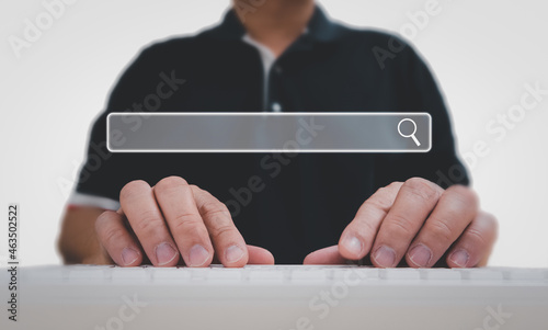 Man using a computer keyboard for searching for information, data search technology search engine optimization.
