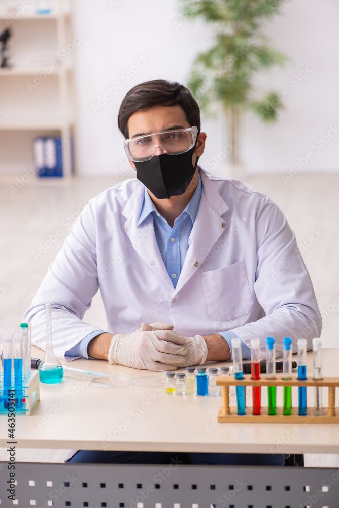 Young male chemist working at the lab during pandemic Young male chemist working at the lab during pandemic