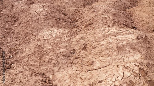 Mounds of dirt: fertile soil texture. Rough surface of brown displaced uncultivated earth, plowed and cracked. photo