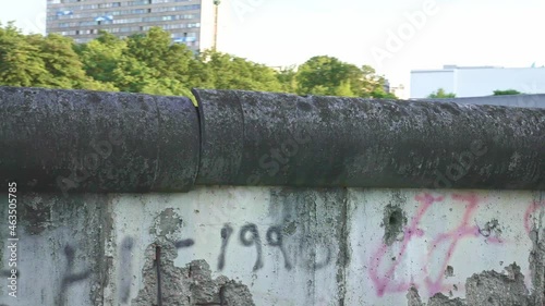 Remains of Berlin wall in Berlin, Germany. Concrete wall, barrier of East Berlin. memorial tourism destination for tourists. Historic landmark.
 photo