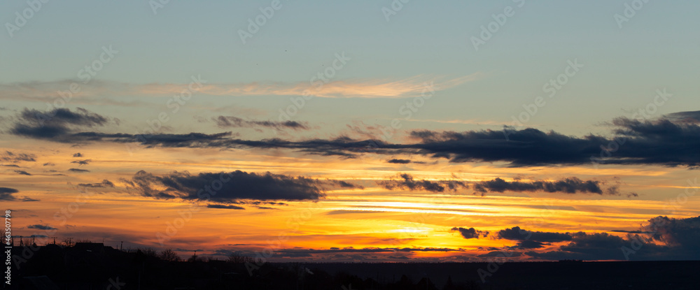 Fototapeta premium The evening sunset. Panorama. Majestic Storm Clouds. Tragic gloomy sky.