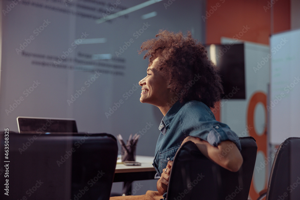 Side view of happy Afro American lady working at her workplace with laptop. Business, employment concept
