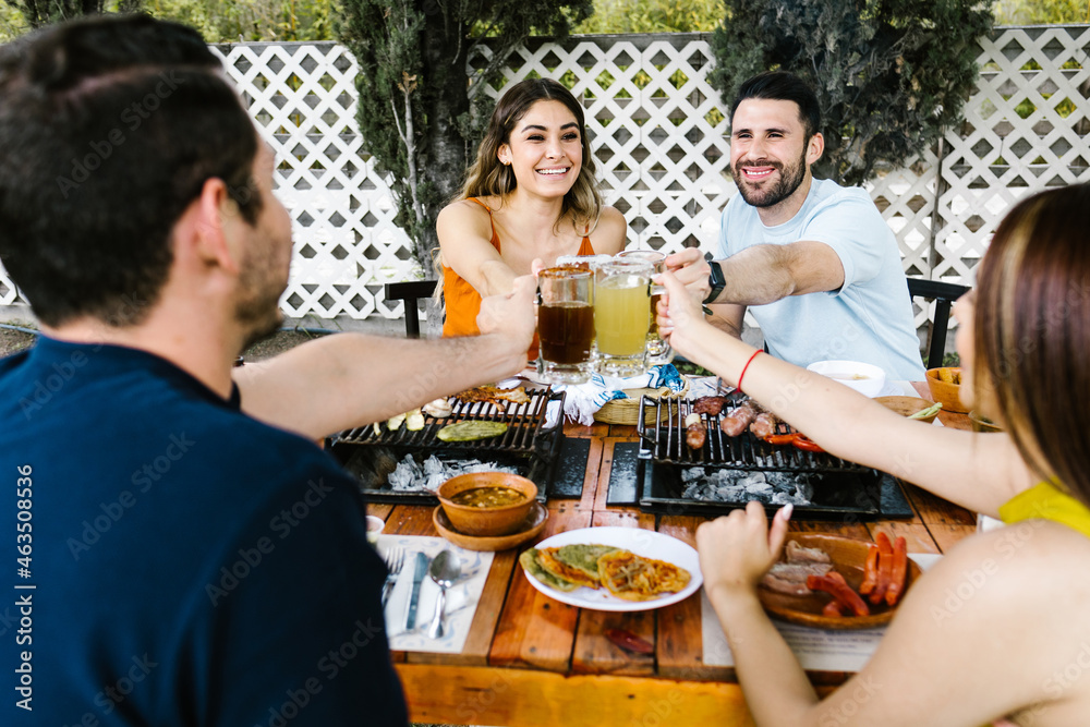 Group of Young latin Friends Meeting For beer, michelada Drinks And mexican Food Making A Toast In Restaurant terrace in Mexico Latin America Group of Young latin Friends Meeting For beer, michelada Drinks And mexican Food Making A Toast In Restaurant terrace in Mexico Latin America