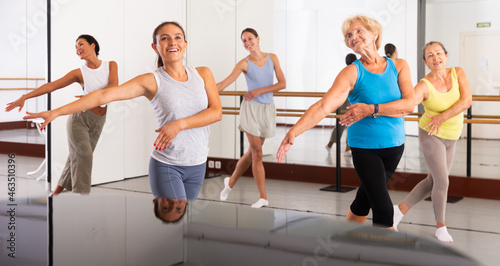 Energetic women performing modern dance in fitness studio