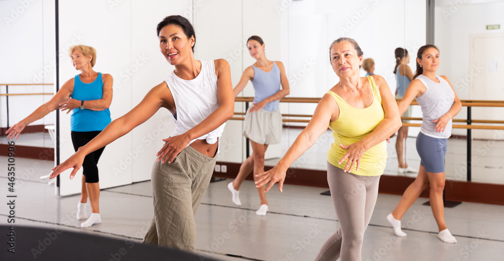 Fototapeta premium Positive women of different ages dancing strip plastic in a dance class