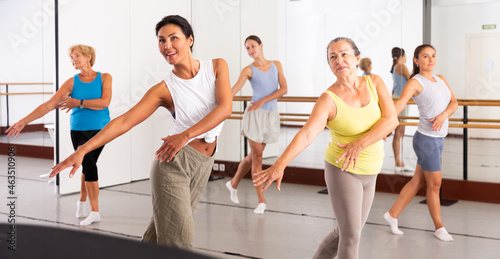 Positive women of different ages dancing strip plastic in a dance class