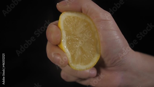 hand squeezing lemon slow motion