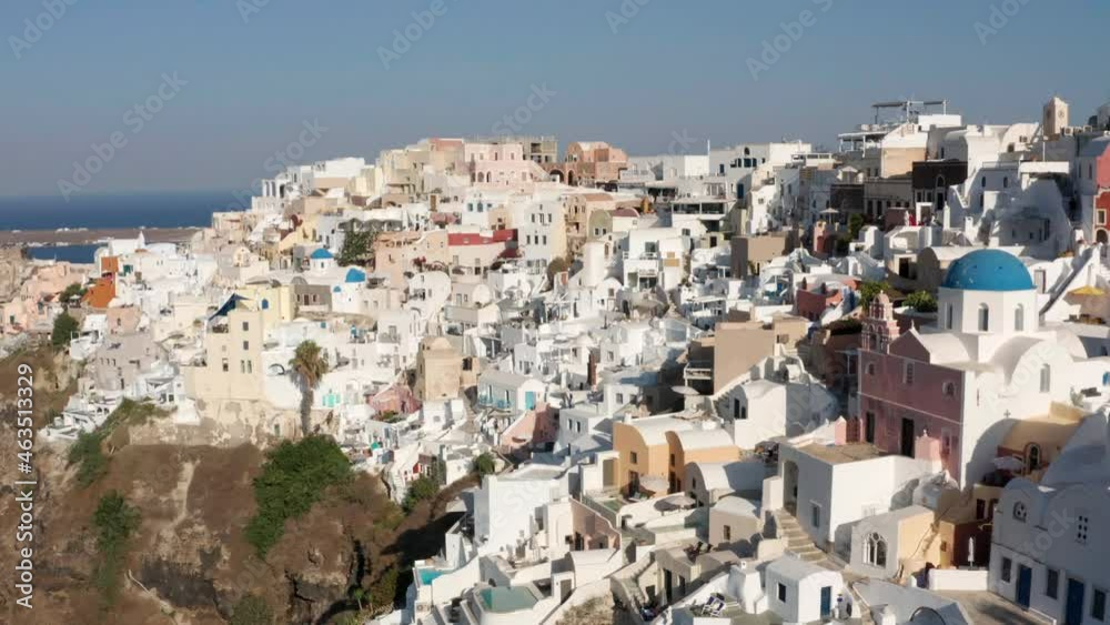 Beautiful Houses At The Coastal Village Of Oia On A Sunny Day In Santorini, Greece. aerial Beautiful Houses At The Coastal Village Of Oia On A Sunny Day In Santorini, Greece. aerial
