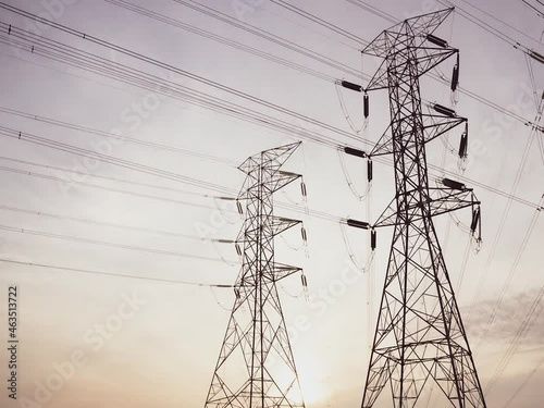 Time lapse of High voltage electric towers at sunset. Transmission power line. Parts of electrical equipment and high voltage power line insulators in the evening.