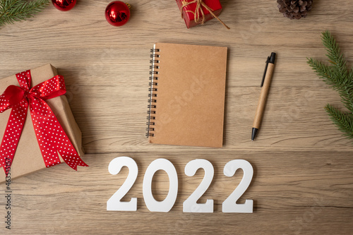 2022 New Year with notebook, Christmas gift and pen on wood table. Xmas, Happy New Year, Goals, Resolution, To do list, start, Strategy and Plan concept