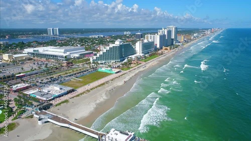 Drone flying away from Daytona Beach shore revealing coastline vista photo