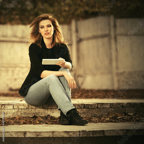 Young fashion blonde business woman using tablet computer