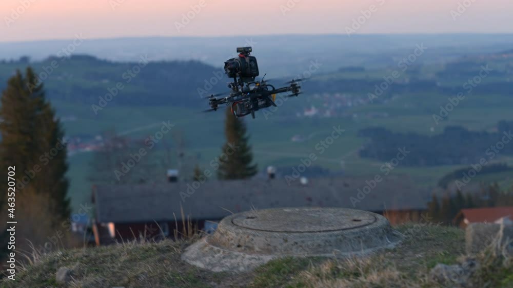 Big FPV drone flying with a DSLR camera attached to it in Grunten, Bavaria, Germany