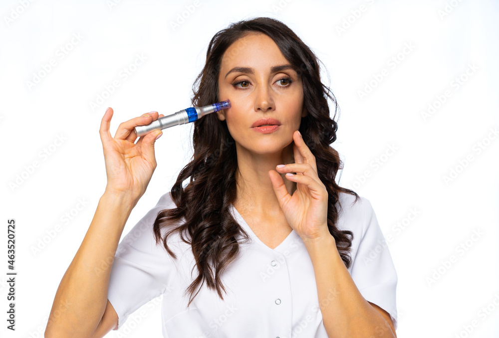 professional woman holding an injection device in the salon. beauty industry. A master in a white jumpsuit with a gold belt. portrait. certified specialist. isolated white background. professional woman holding an injection device in the salon. beauty industry. A master in a white jumpsuit with a gold belt. portrait. certified specialist. isolated white background.