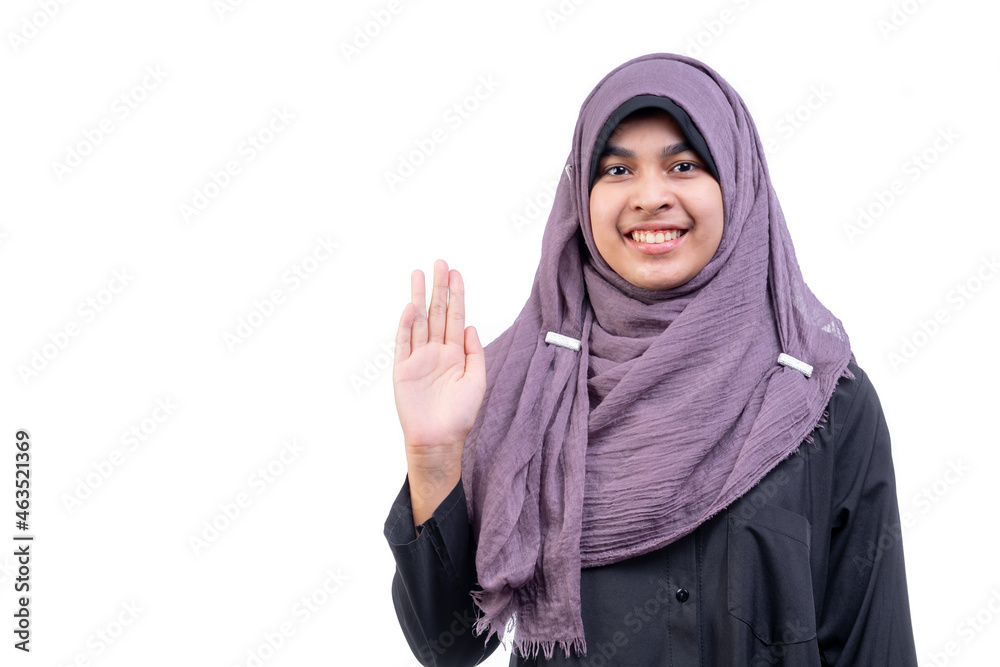 A beautiful Asian Muslim woman standing, hello, greeting with a smiley face, on white background. A beautiful Asian Muslim woman standing, hello, greeting with a smiley face, on white background.