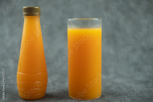 Orange juice in glass and orange juice in bottle