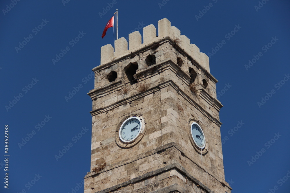 Obraz premium old turkish tower with clock on a blue sky background