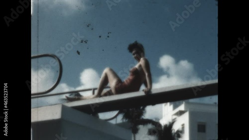 Posing Beauty 1949 - A woman in a bathing suit poses poolside.   photo