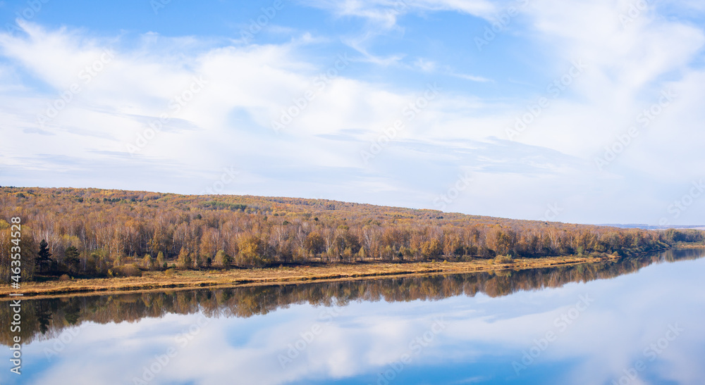 Beautiful, wide river autumn among the woods. Calm and quiet place with autumn colors. In the middle of the river island. View from the top to the distance Beautiful, wide river autumn among the woods. Calm and quiet place with autumn colors. In the middle of the river island. View from the top to the distance