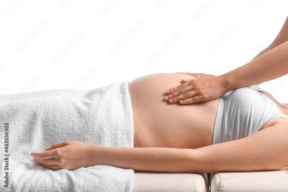 Obraz premium Young pregnant woman having massage against white background