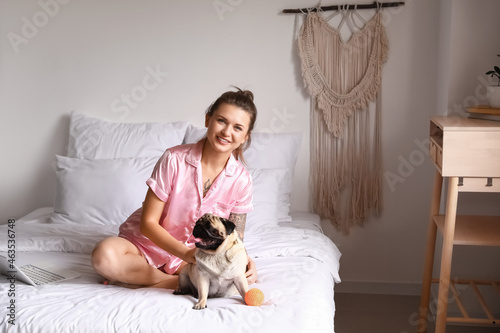 Young woman playing with cu...