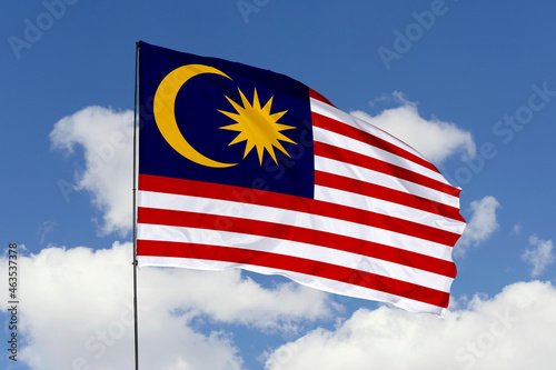 Malaysia flag isolated on the blue sky background. close up waving flag of Malaysia. flag symbols of Malaysia. Concept of Malaysia.