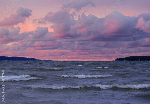 a  pastel sunset across the waves of the  grand traverse bay of  lake michigan, in traverse city, michigan photo