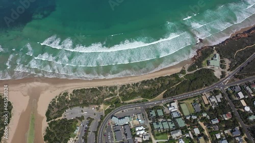 Vertical aerial tilts from Anglesea to shallow ocean bay in Australia photo