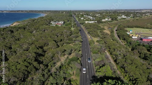 Low aerial follows traffic on Bellarine Hwy in Ocean Grove, Australia photo