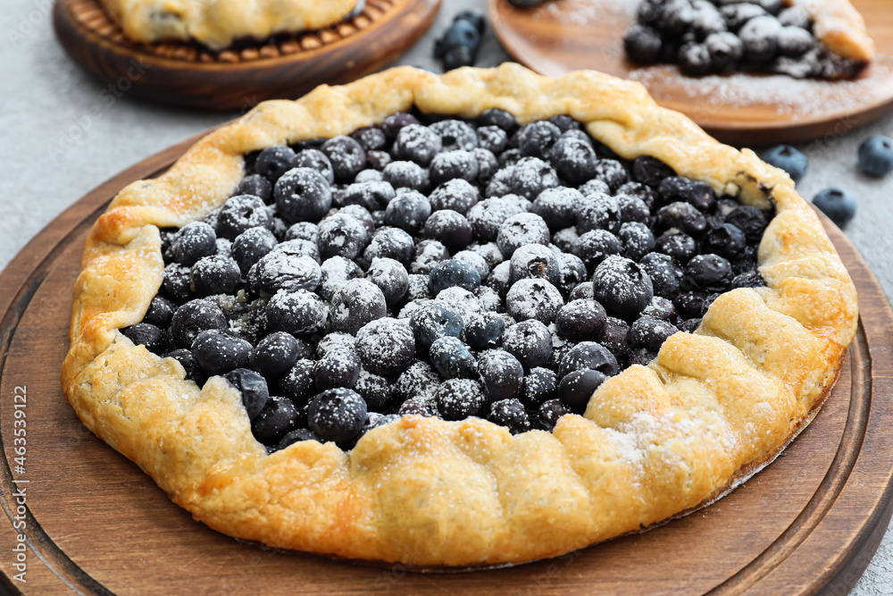 Board with tasty blueberry galette on table, closeup Board with tasty blueberry galette on table, closeup
