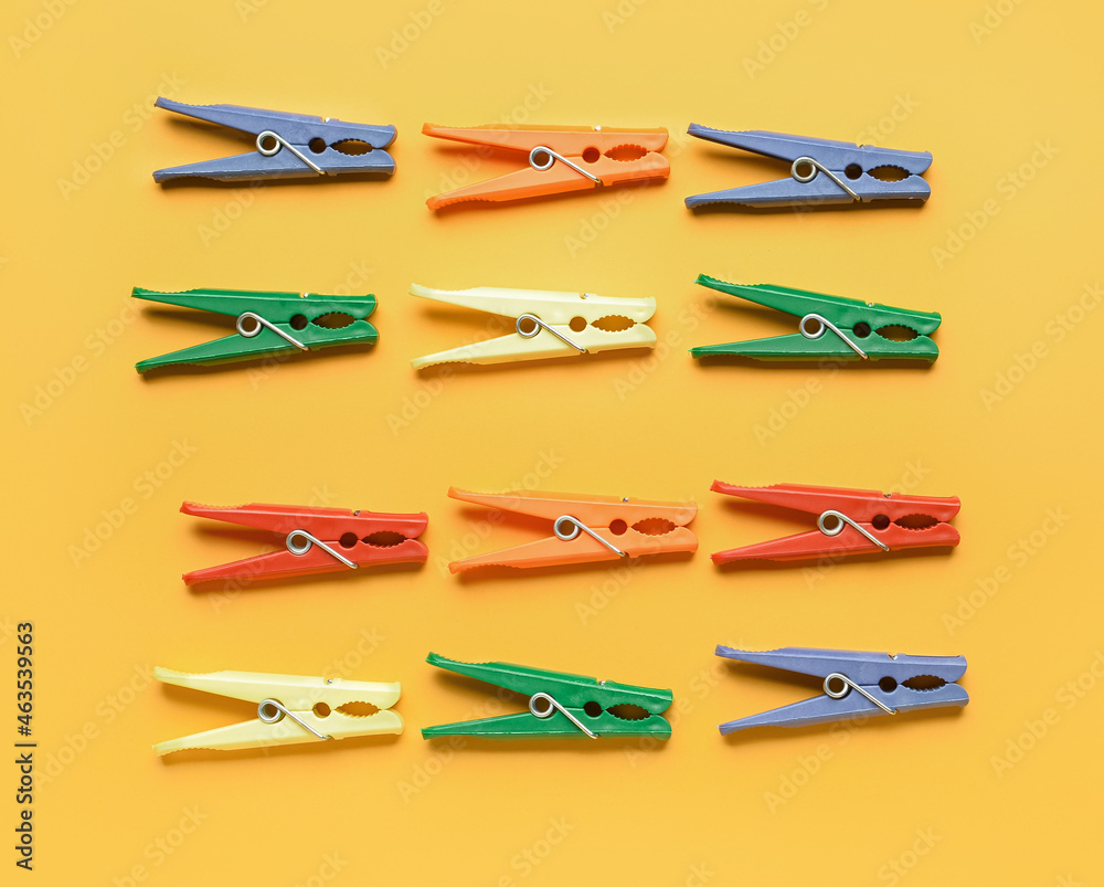 Many plastic clothespins on color background Many plastic clothespins on color background
