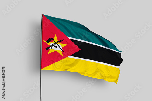 Mozambique flag isolated on the blue sky background. close up waving flag of Mozambique. flag symbols of Mozambique. Concept of Mozambique.