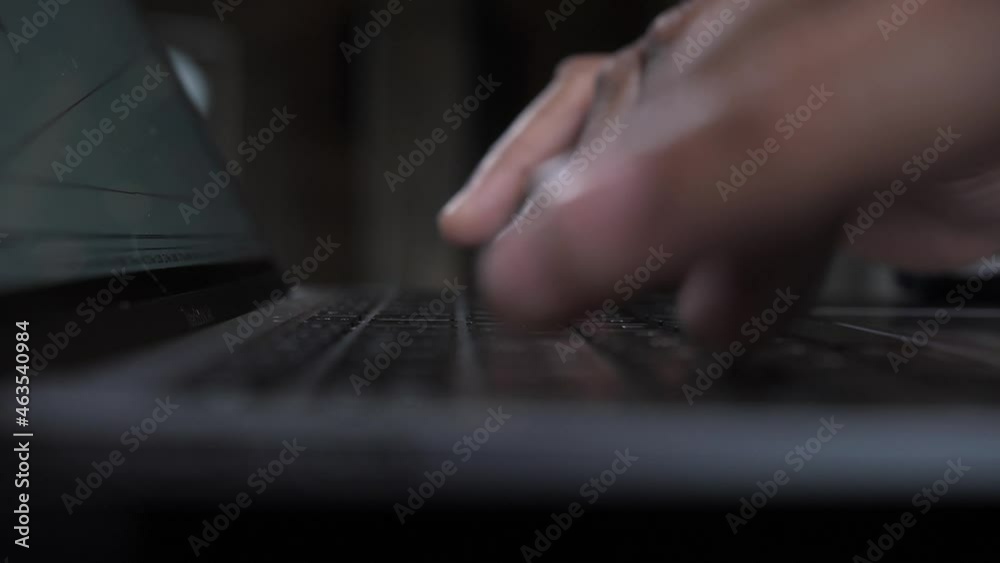 Close-up hands typing on computer laptop, african black man working from home Close-up hands typing on computer laptop, african black man working from home